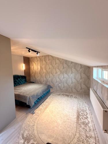 a bedroom with a bed and a rug at Apartament studio in Durleşti