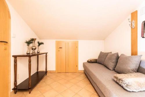 a living room with a couch and a table at The Alpine No 7 in Reith bei Seefeld