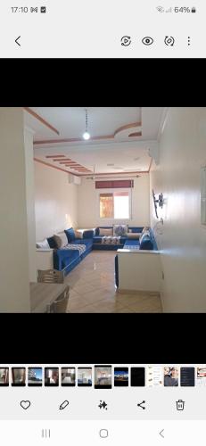 a living room with blue couches in a room at Dar Larache in Larache