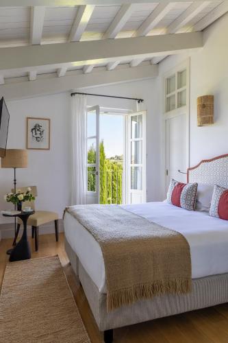 a bedroom with a large bed and a window at Locanda Rossa in Capalbio