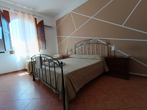 a bedroom with a bed in a room at Albergo diffuso Borgo Gallodoro da Sara in Gallodoro