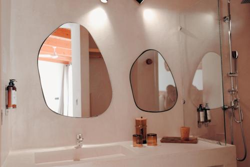 two mirrors above a sink in a bathroom at White Dune Canyon in Dakhla