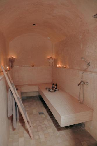 a bathroom with a tub and a shower in it at White Dune Canyon in Dakhla
