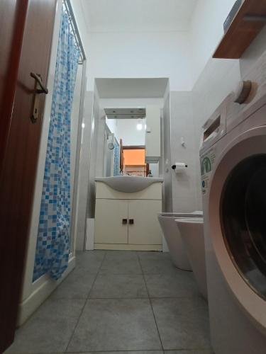a bathroom with a sink and a washing machine at AL40 - Turin Holiday Apartment in Turin