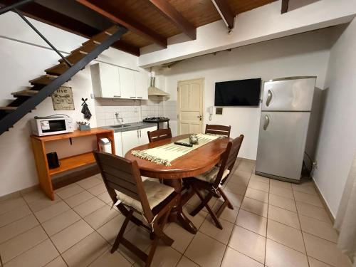 a kitchen with a wooden table and a refrigerator at Depto alquiler por día in Apóstoles