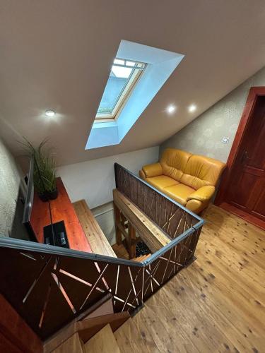a living room with a couch and a skylight at Chalupa Ořechov in OÅ™echov