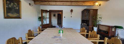 a dining room with a long table and chairs at Chalupa Ořechov in OÅ™echov