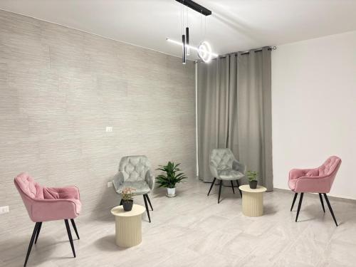a waiting room with pink chairs and plants at Il Castagno in Vasto