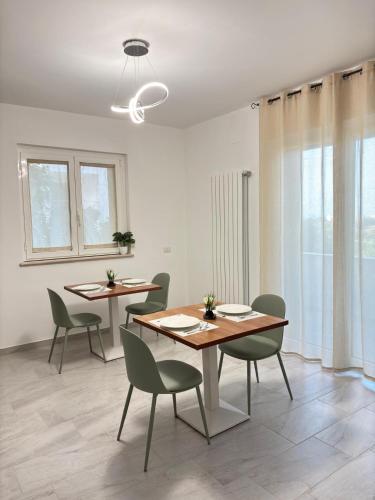 a dining room with two tables and chairs at Il Castagno in Vasto
