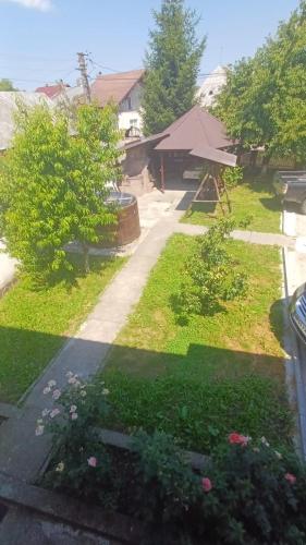 a view of a yard with grass and flowers at Casa Vlad-Alex in Săpânța
