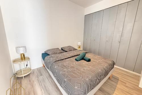 a bedroom with a bed in a white room at Le St Roch - Cosy & Confort in Roanne