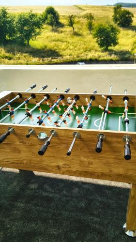 a wooden table with a rack of hockey sticks at Hotel Adamantino in Luhačovice