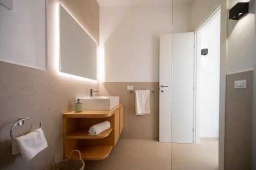 a bathroom with a sink and a mirror at Macchia Piccinna in Maruggio