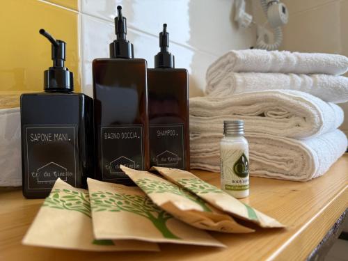 a bathroom counter with two bottles of soap and towels at Ca du Ginetto B & B in Borgio Verezzi