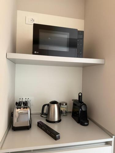 a kitchen counter with a microwave and a coffee maker at Palazzo Righi in Carisolo