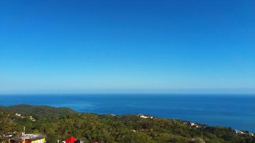 a view of the ocean from the top of a hill at Bayview Luxury Retreats 