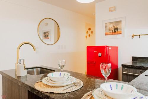 a kitchen with a sink and a red refrigerator at Upscale 2BR Gym & Bright View in Barranco in Lima