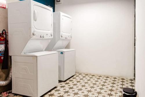 a kitchen with two washer and dryers in a room at Upscale 2BR Gym & Bright View in Barranco in Lima