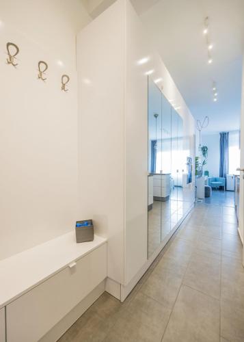 a room with white walls and a large mirror at Madach Studio - Heart of Budapest in Budapest