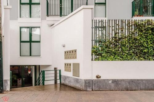a white building with a plant on the side of it at Delightful 2BR Amazing View in Barranco in Lima