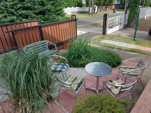 a patio with chairs and a table and chairs at Loft Apartman in Zalakaros