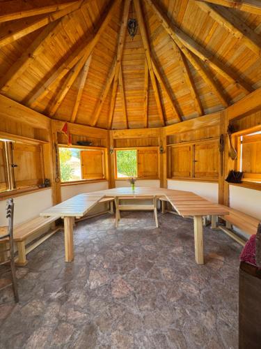 a room with benches and tables in a wooden cabin at The Fairy Valley Villa Boutique in Pluzine