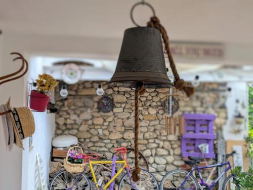 a bell hanging from a stone wall with two bikes at Casa Paula in Orcheta
