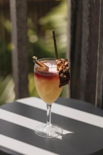 a drink in a glass sitting on a table at Pousada Maria Flor in Fernando de Noronha