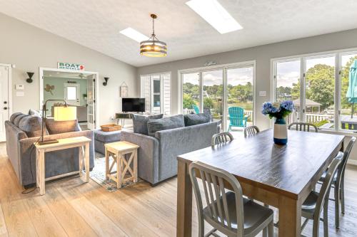 a living room with a table and a couch at Boat Dock and Kayaks Waterfront Home in Deltaville! in Deltaville