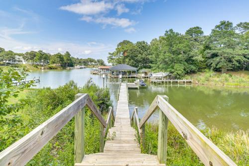 a wooden bridge over a river with a dock at Boat Dock and Kayaks Waterfront Home in Deltaville! in Deltaville