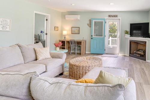a living room with a couch and a fireplace at Boat Dock and Kayaks Waterfront Home in Deltaville! in Deltaville