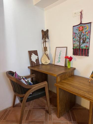 a room with a desk and a chair and a guitar at The Fairy Valley Villa Boutique in Pluzine