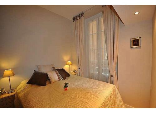 a bedroom with a large bed with a window at Rossetti in Nice