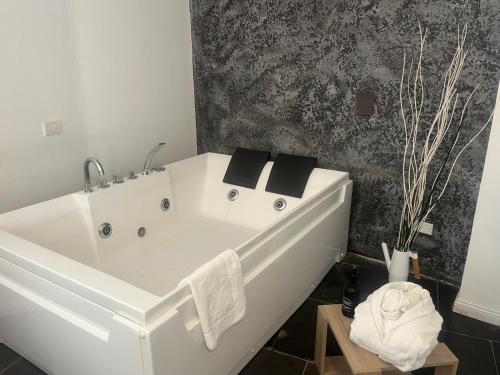 a bathroom with a white bath tub in a room at Hotel Terme Neronensis in Pozzuoli