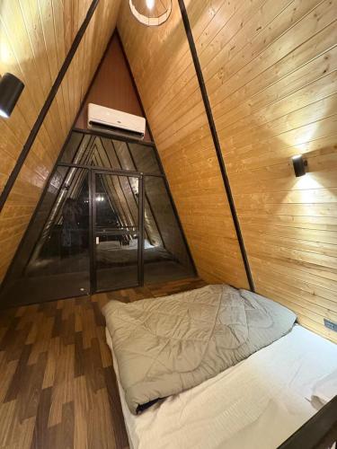 a small bed in a small room with a window at Dunewood Resorts in Ani