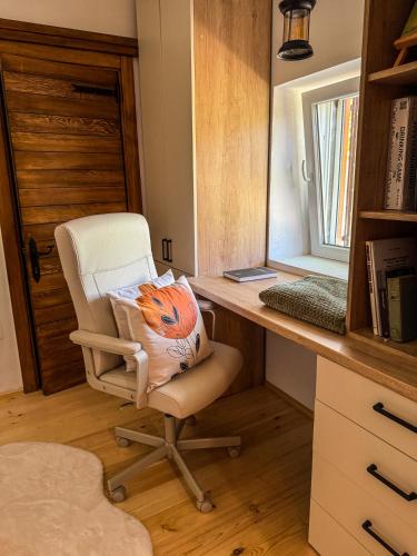 a desk with a chair with a pillow on it at The Fairy Valley Villa Boutique in Pluzine