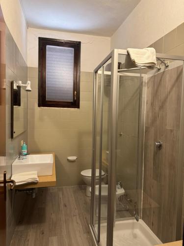 a bathroom with a shower and a sink and a toilet at Villa Francesca in Flumini di Quartu
