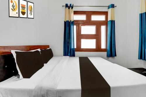 Ένα ή περισσότερα κρεβάτια σε δωμάτιο στο Hotel O Welcome Guest House