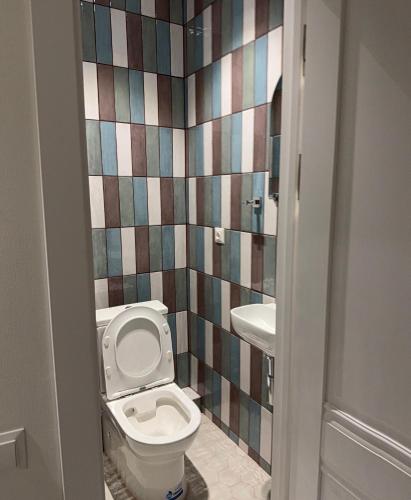 a bathroom with a toilet and a sink at apartment Tashkent 2 BR centre main St in Tashkent