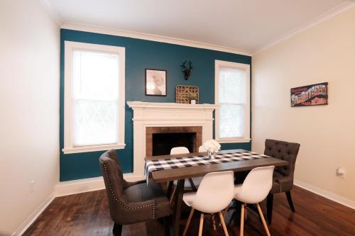 a dining room with a table and chairs and a fireplace at 438M- 3 BR Apt with Free Parking on Premises and Coffee in San Antonio