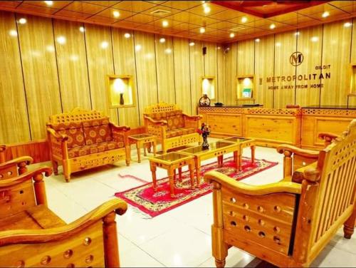 a large room with wooden benches and tables at The Metropolitan Hotel Gahkuch in Dargai