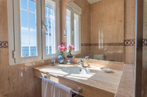 a bathroom with a sink and a large window at Villa Girasol in Calahonda