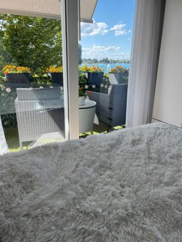 a bedroom with a bed and a view of a balcony at Studio Marylin in Rorschach