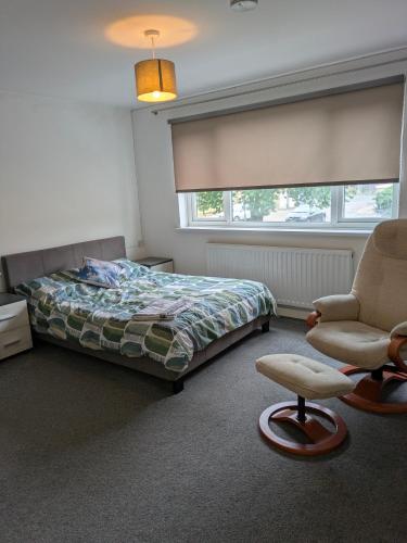 a bedroom with a bed and a chair and a window at Special Offer CORBY En- Suite Double Room Near Rockingham Min 4 night stay for Couples or Single person Available in Shared property & fully equipped in Rockingham