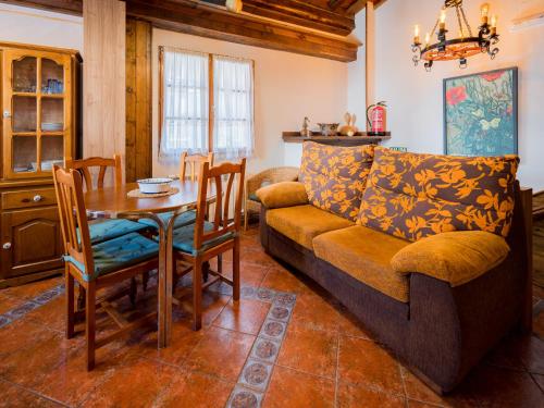 a living room with a couch and a table at Apartamentos Rurales Les Martes in Felechosa