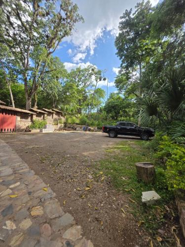 a black car parked in a parking lot at Cabaña Alpina Monte Carlo in Copan Ruinas