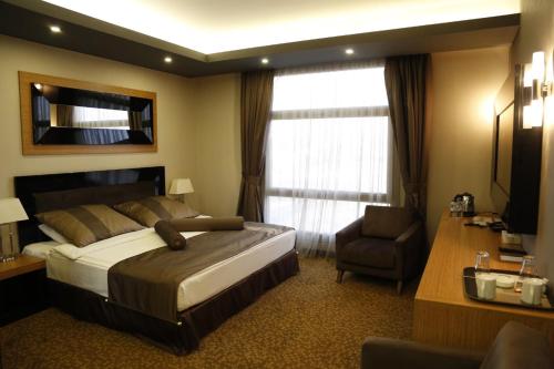 Ein Bett oder Betten in einem Zimmer der Unterkunft Erbil Quartz Hotel