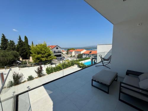 a balcony of a house with a view of a pool at Alma Mare - Modern Apartment with Soul & View in Murter