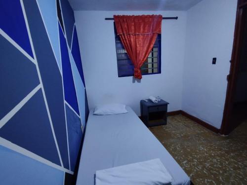 a small room with a bed and a window at Welcome Home Cali in Cali