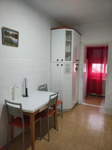 a kitchen with a table and chairs and a red door at Enjoy Pirineos in Huesca